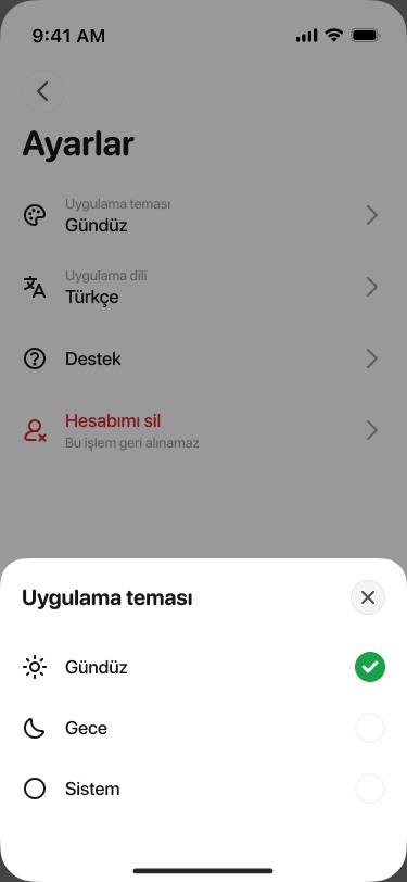 Settings screen dimmed behind a bottom sheet for choosing the app theme: day, night or system
