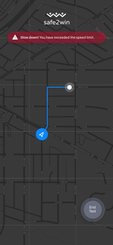 Dark map with a blue route line, a red 'Slow down! You have exceeded the speed limit' banner and a round End Test button